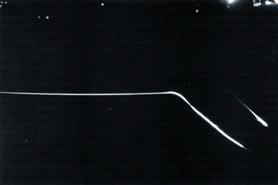 Flight test of the Advanced Maneuvering Reentry Vehicle in early 1980. The path of the reentry vehicle is the upper streak of light, with the booster tanks immediately below.