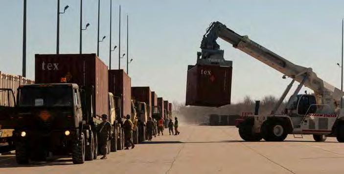 Soldiers offload shipping containers in McAlester, Oklahoma, during Patriot Bandoleer, a long-haul transportation mission covering approximately 3,400 miles from Oklahoma to Concord, California, and