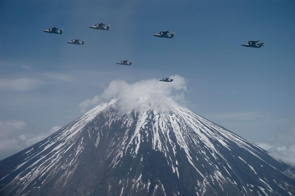 Above Mount Fuji, five E-2D Advanced Hawkeyes, stationed at Marine Corps Air Station Iwakuni, Japan, lead two E-2C Hawkeyes, stationed at Naval Air Facility Atsugi, Japan, as part of Asia-Pacific