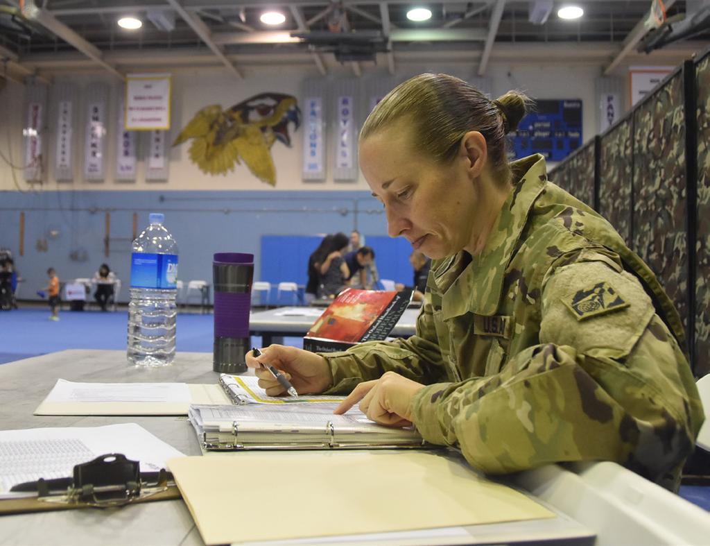 Kimberly King, Far East District operations noncommissioned officer in charge, works diligently during the Eighth Army Focused Passage 2017 exercise held at Seoul American High School Falcon Gym June