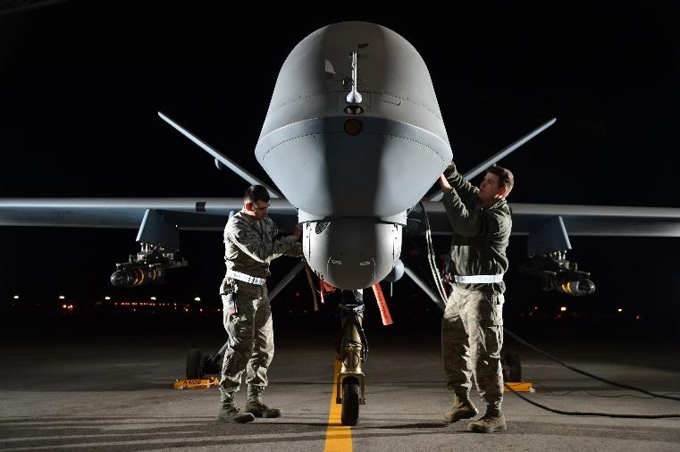 Airman 1st Class Steven and Airman 1st Class Taylor prepare an MQ-9 Reaper for flight during Combat Hammer May 15, 2014, at Creech Air Force Base, Nev.