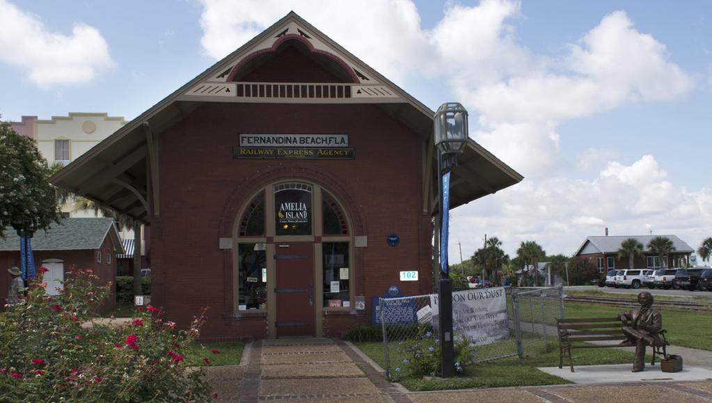 1 The 1899 brick train depot, which is on the National Register of Historic Places as a contributing structure in the Fernandina Beach Historic District, is built on grade and located approximately