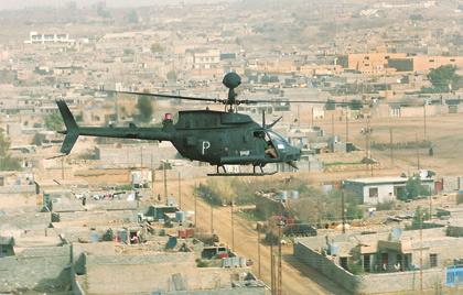 A U.S. Army OH-58D Kiowa helicopter from the 3rd Armored Cavalry Regiment (ACR) conducts a combat air patrol over the ancient city of Tal Afar in February 2006.