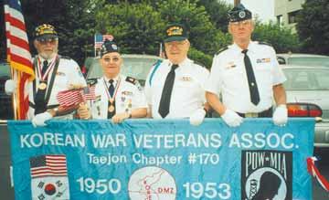 Banner carried at Rochelle Park parade being carried by (L-R) Gereal