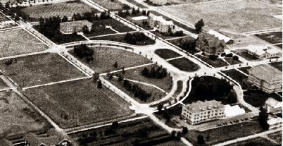 Duck Pond (referred to then as Frog Pond) with Traphagen Hall in the background (left) and Romney Gymnasium (right) circa 1922.