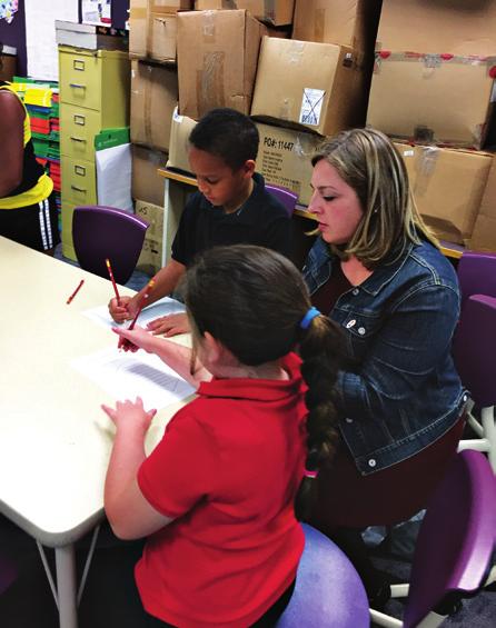 Angie Cameron assists after-school students in literacy and mathematics.