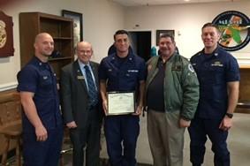 Unit Adoption Certificate to CDR Fredie and MECM Christopher Ellis with crew of TACLET South in the