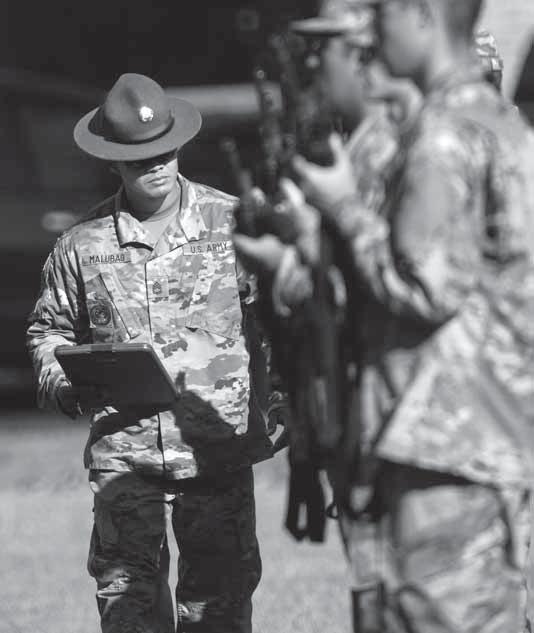 1st Class Daniel Malubag, a drill sergeant, watches intently as Soldiers in Training,