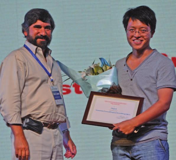 Hongxin Wu (middle), Chair of the Poster Award Evaluation Committee, presents the Poster Award to Zhenyan Wang (left) and Baocang Ding (right), respectively. Christos G.
