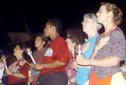 html (Photo by Jim Bennett) From left, Denise Morrow, Brenda Panton, Debbie Thomas, Cathy Cutshaw and Ivy Springer hold their candles and sing the national anthem Saturday night at the flag poles