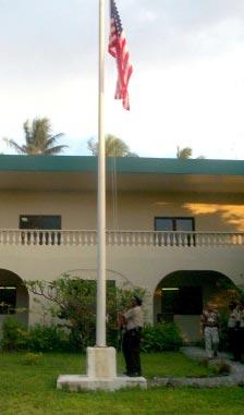 (From page 1) (Photo courtesy of U.S. Embassy in Majuro) The American flag is lowered during a memorial ceremony at the American embassy in Majuro Wednesday.