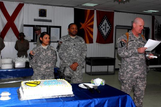 Robert Gilford (center), the brigade operations sergeant major, cut the cake during the Army s 234th Birthday celebration on JSS WarEagle.