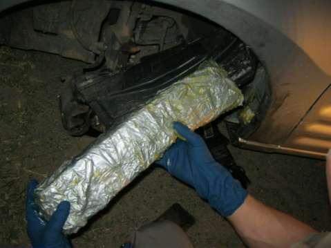 011 lbs of cocaine concealed inside the driver s shoes in a 2004 Cadillac