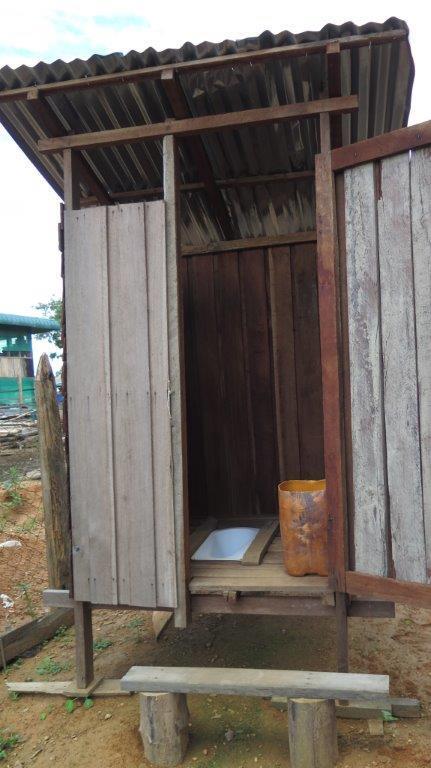 The family has also provided soap and water inside the latrine for users to practice good handwashing hygiene and a scrubbing brush to keep the latrine clean.