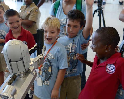 Senior Airman Jenay Randolph Students from Discovery Academy of Science watch the Air Force medium robot