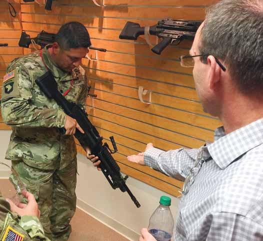 Outside of the box Senior leaders tour weapons manufacturing plant By WALLACE MCBRIDE Fort Jackson Leader Scott Fisher, vice president of operations at FN America, gives Lt. Col.