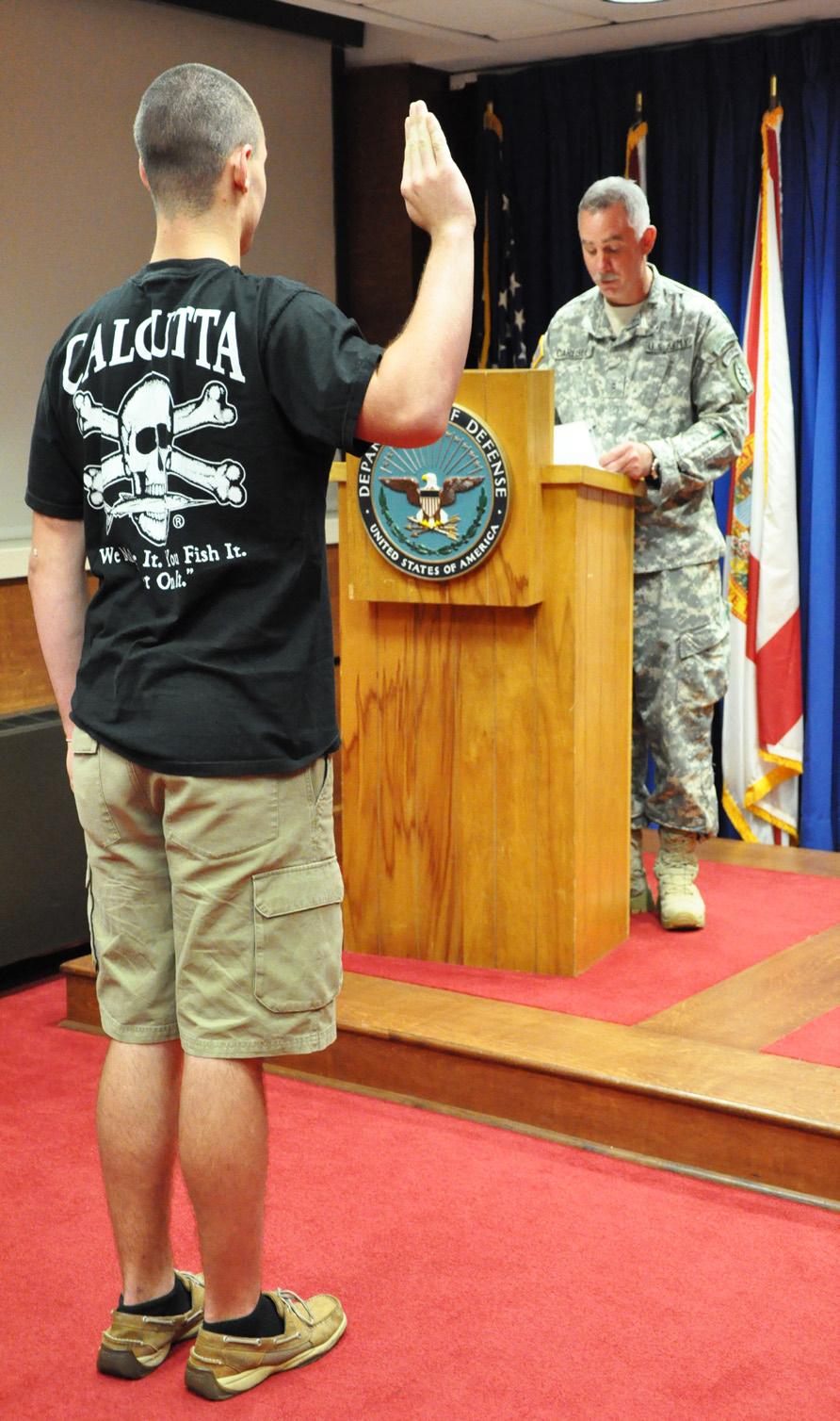 %UHQGD 7KRPDV/photo Pvt. Robert Carlisle takes the Oath of Enlistment into the Alabama Army National Guard at the Montgomery Military Entrance Processing Station (MEPS) in July.