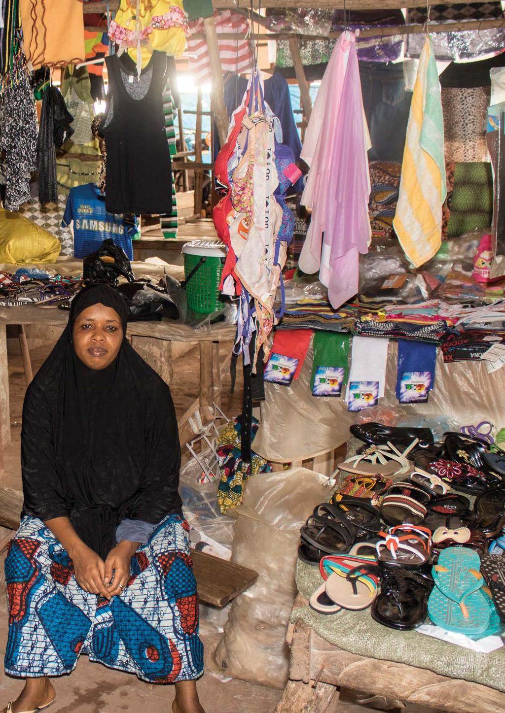 4 Stallholder Afsatu sells shoes and T-shirts in the rehabilitated section of Rokupr market.