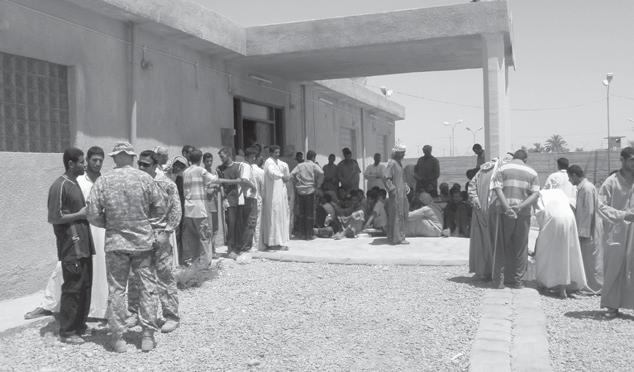 (U.S. Army, LT Scott Marler) Iraqi men gather outside of the Balad Joint Security Station to enter into a cease-fire agreement as part of the reconciliation process, 10 June 2008.