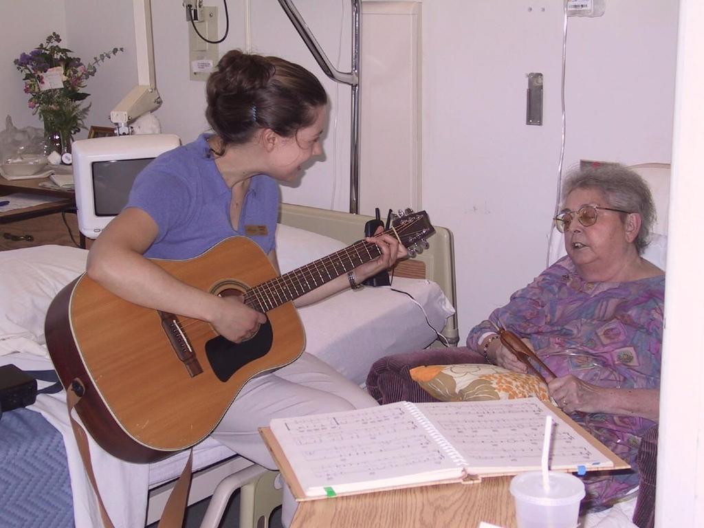 Music Therapist (Kirsten) sings with a patient
