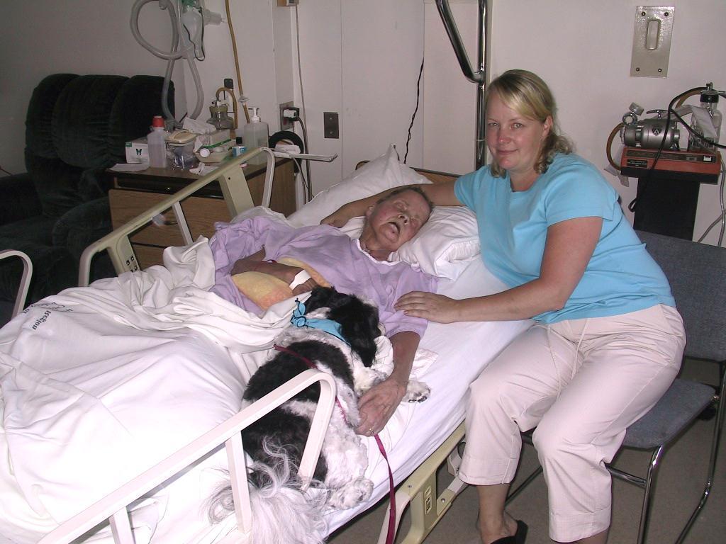 Daughter sits with her Mom who has lung cancer.