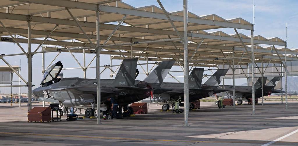 1 2 3 1 A lineup of F-35As sit under sun shades on the ramp.