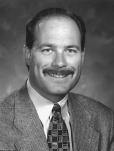 After serving as the associate athletics director for external operations for two years, Pugmire was appointed to the position of athletics director on July 16, 1999, replacing Bruce Van De Velde,