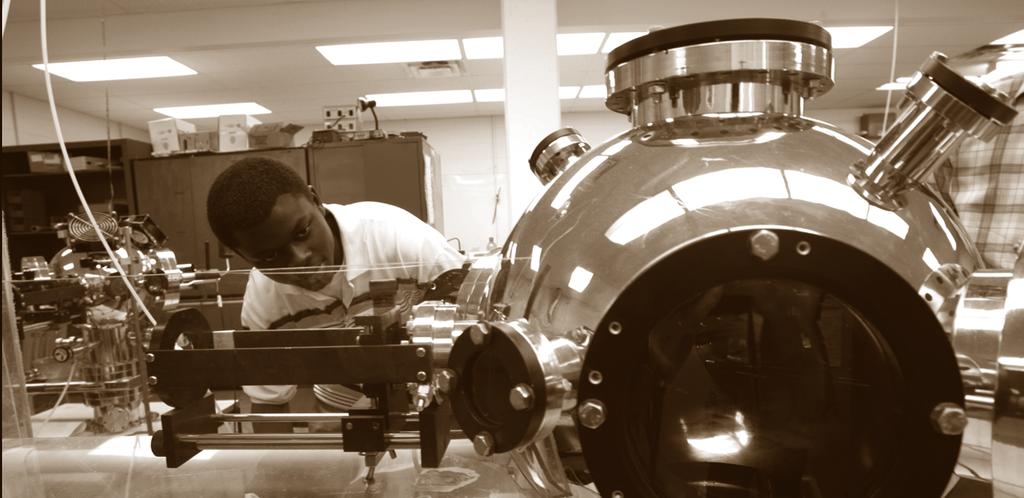 Justice Alaboson, a graduate of the physics astronomy and materials science department at Missouri State University, works in the Pulsed Laser Deposition laboratory at the Jordan Valley Innovation