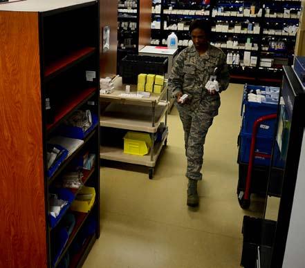 places a container on the conveyor belt at MacDill Air Force Base, March