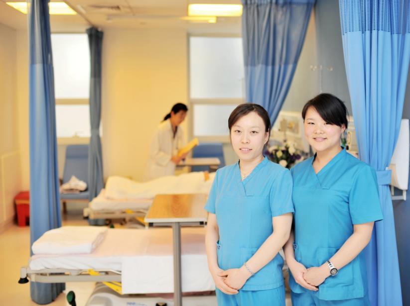 nurses talk to each other in the room, they are speaking in Chinese that makes it look like they are not