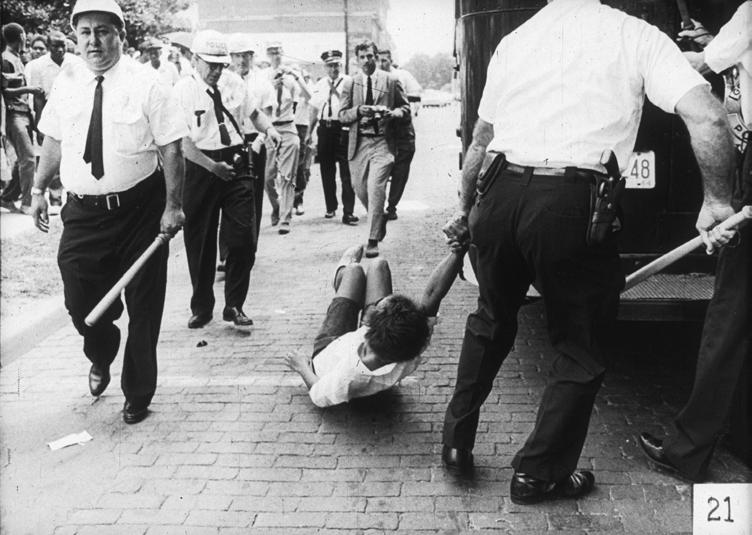 54 SOUTHERN QUARTERLY A young woman goes limp as she is dragged off by police on Greenwood Freedom Day, 16 July 1964. Greenwood, Mississippi.