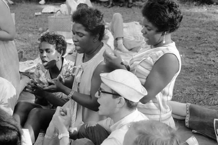 58 SOUTHERN QUARTERLY Freedom Summer volunteers and local people singing at a fish fry hosted by local civil rights leader Vernon Dahmer on 4 July 1964, on his property in the Kelly Settlement north