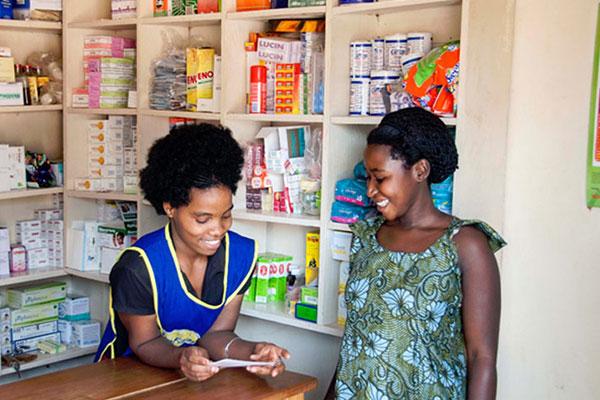 (Photo credit: PACE-Uganda [KK Big Sky]) Donata (left) owns Central Clinic, a local drug shop in Mubende.