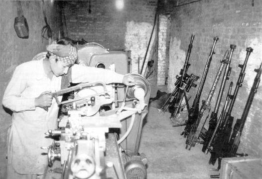 Dara, Pakistan. A young gunsmith making not repairing knock-off copies of various machine guns at the Alice s Restaurant of firearms.