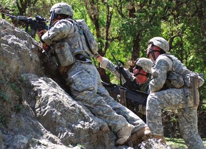 Capt. John Williams (left), commander of Headquarters and Headquarters Troop, 1st Squadron, 91st Cavalry Regiment (Airborne), observes the hilltop while SSgt. William Randall (center) directs Sgt.