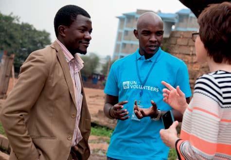 National UN Volunteer Project Manager George Gachie (Kenya) shares a moment with another UN Volunteer in Kibera slums, after introducing a visiting consultant to the community where he is leading a