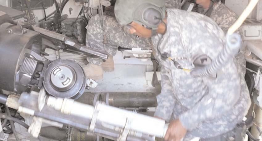 Vincent Brooks, deputy commanding general for support for the Multi-National Division-Baghdad and 1st Cavalry Division, prepares to load an M109A6 Paladin howitzer for firing at Camp Taji, Iraq July