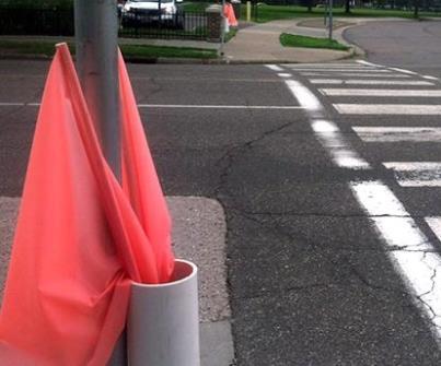 These flags are tools that pedestrians can use to signal motorists of their intention to cross the street.