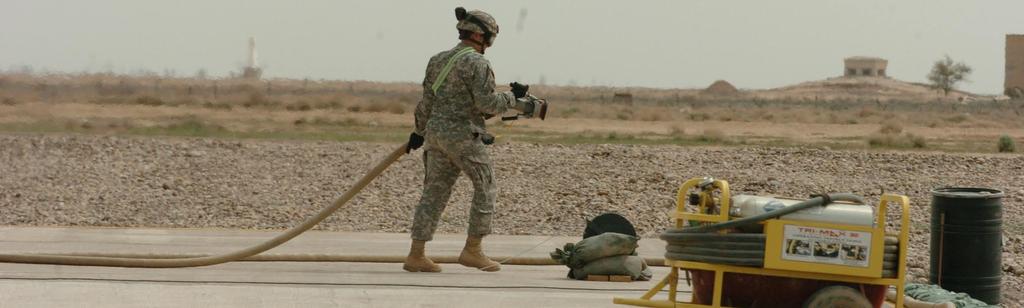 (ABOVE) A Soldier puts away the fuel nozzle after refueling a UH-60 Blackhawk at the Assault forward armarment and refueling point at Logistical Support Area Anaconda, Iraq.