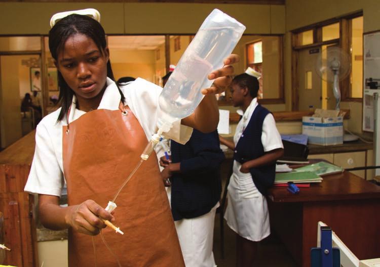 q Nursing student Dorothy Banda clears an IV line of air at Mulanje District Hospital.