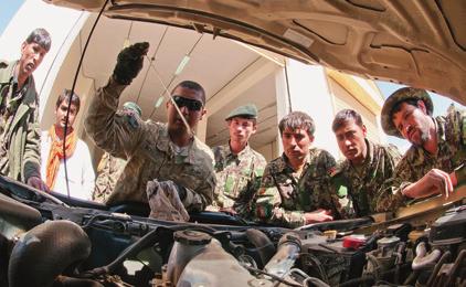 SPC Louis Morales, a mechanic with the 307th Brigade Support Battalion, explains to Afghan National Army drivers how to properly read a dipstick during preventive maintenance.