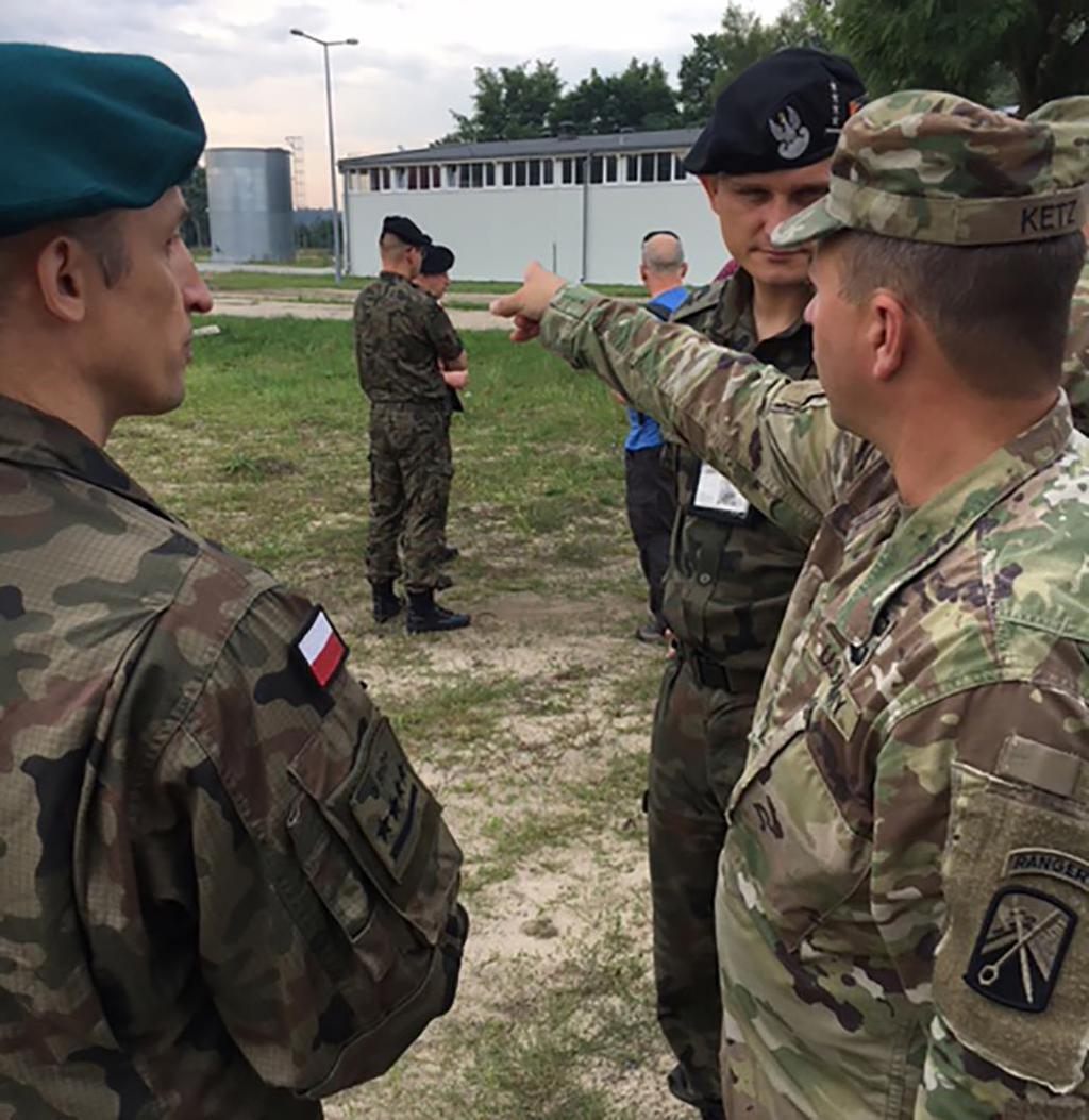 Figure 4. LTC Brian Ketz, 16 th STB commander, surveys logistical nodes at Camp Karliki, one of seven ISBs, with Polish HN representatives July 19, 2017.