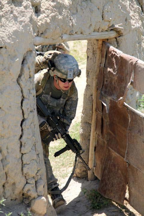 A mortarman from Bulldog Troop, 1st Squadron, 91st Cavalry Regiment, 173rd Airborne Brigade Combat Team moves through a small door in a qalat wall while travelling dismounted during a mission in