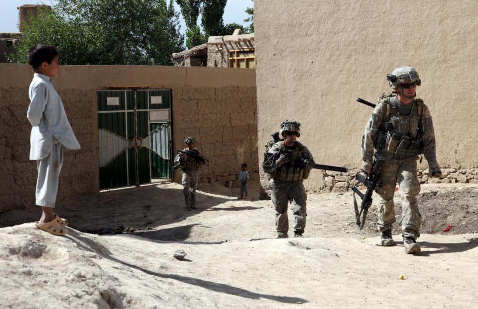 U.S. Army paratroopers from 1st Platoon, Bulldog Troop, 1st Squadron, 91st Cavalry Regiment; maneuver through a qalat village in Charkh Valley, Logar Province, Afghanistan, 12 June, 2010.