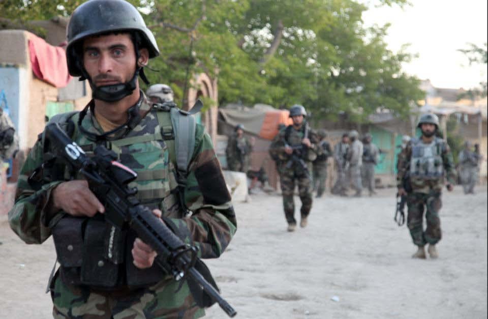 A group of Afghan Commandos conduct a mission to search a bazaar for illegal weapons in Charkh Valley, Logar