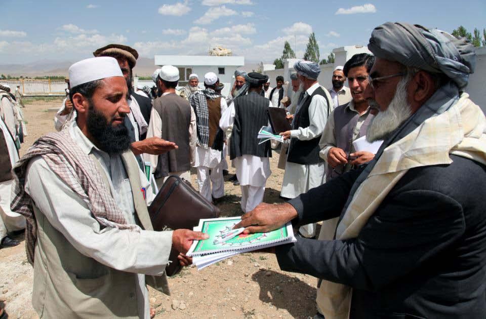 A Principle gives teachers of the Mohammed Ahga district pens and agenda's as a token of appreciation for attending the Mohammed Ahga teachers shura June 19, 2010 Mohammed Ahga, Afghanistan.