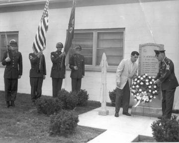 Top: View of wreath being laid in front of monument for the 1958 Nike Ajax explosion at the Highlands Air Force Base in Highlands,