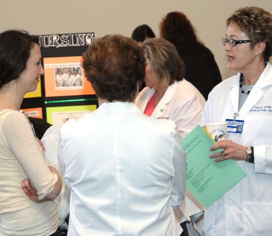 Kimberly Vernier, A.P.R.N., with the Interventional Pain Center, talks to nurses at one of the booths at last year s Nursing Staff Summit.