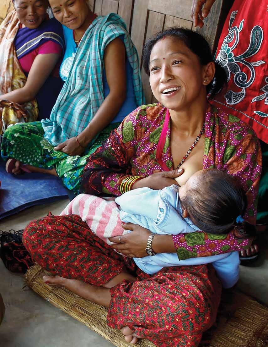 A young mother, Manju Malla, voluntarily demonstrates how to properly breastfeed an infant.