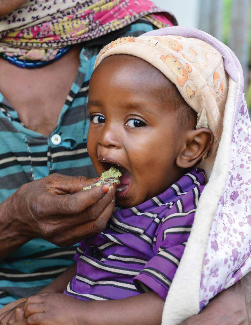 A woman feeds her child a nutritious porridge, made from locally available products, at the health post in the village of Maderia in Gemechis, a woreda (district) of the Oromia Region.